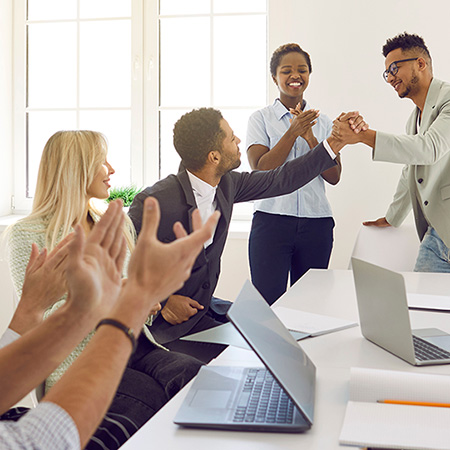 Colleagues celebrating a business win